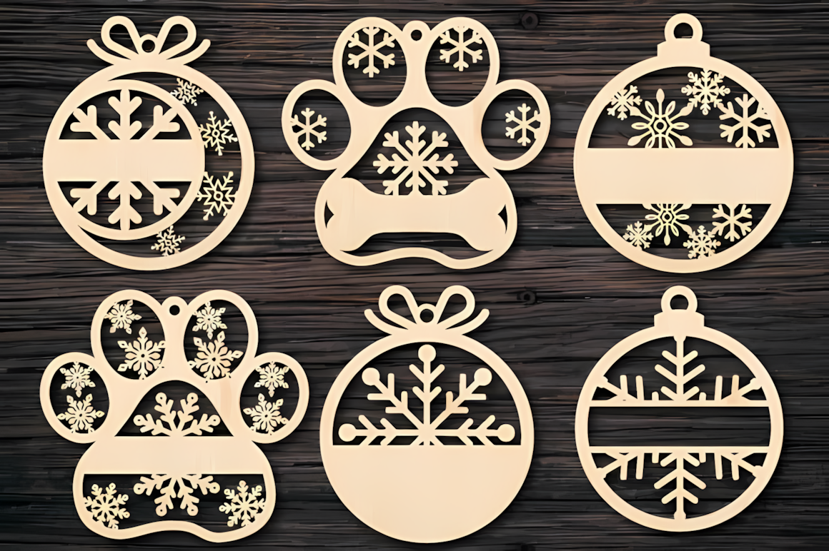 Intricate filigree discs in a laser cut christmas baubles collection displayed on a wooden board
