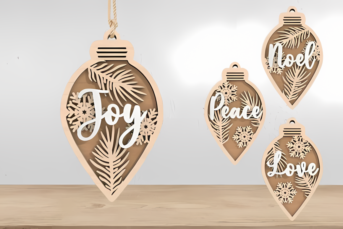 Word cutouts reading joy, peace and noel in christmas ornament laser cut bundles on a rustic mantel
